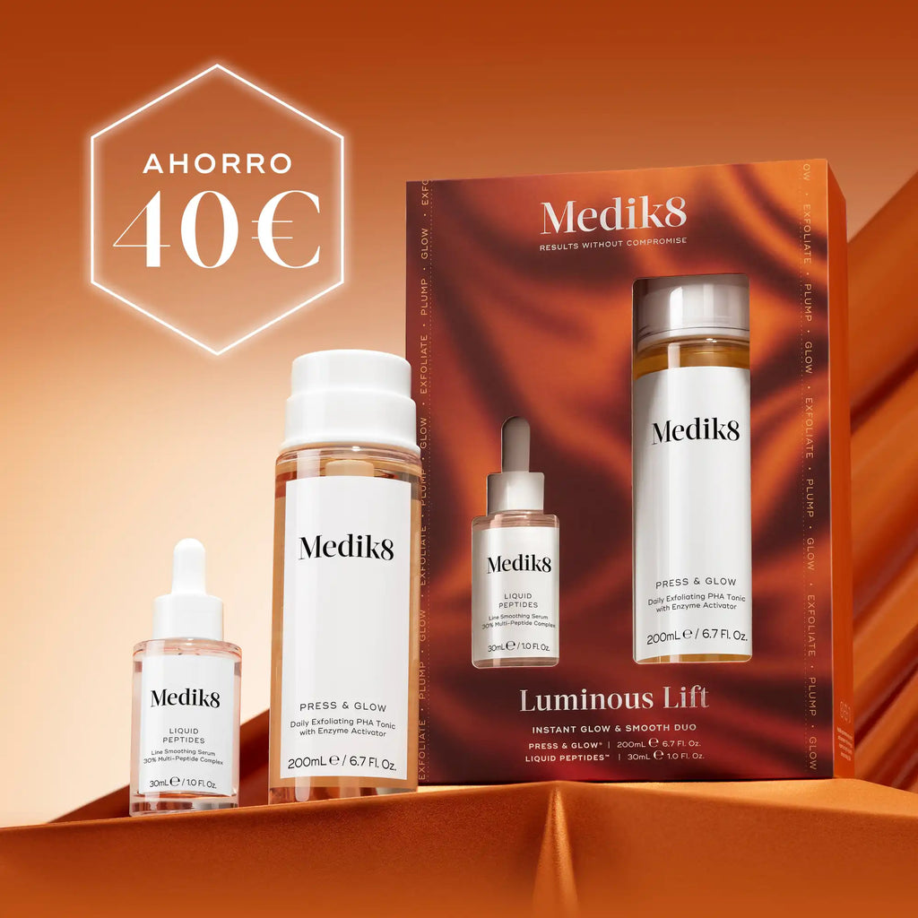 Cuatro productos para el cuidado de la piel de Medik8, entre los que se incluyen un frasco cuentagotas pequeño, dos frascos blancos más grandes y un tarro blanco, dispuestos sobre un fondo naranja oscuro con textura. En la esquina superior izquierda se muestra de forma destacada un hexágono blanco con el texto AHORRO 40€